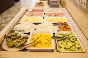 a buffet with different types of food on a table at Hotel Diplomat Palace in Rimini