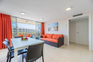 a living room with a table and a couch at Rentalmar Navarra family suites in Salou
