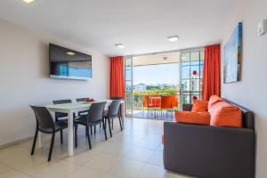 a dining room with a table and chairs at Rentalmar Navarra family suites in Salou