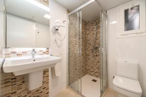 a bathroom with a sink and a shower at Rentalmar Navarra family suites in Salou +22 photos