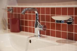 a sink with a faucet in a bathroom at La Mésange in Millau