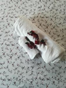 two white socks with cherries on a bed at Villa Giulia in Rimini