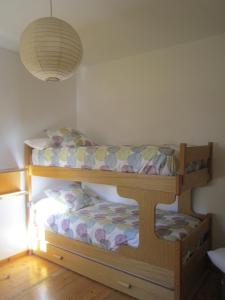 a bunk bed in a room with a lamp at Los Valles 4 in Biescas +13 photos