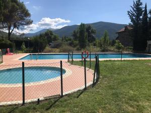 a swimming pool with a fence around it at Los Valles 4 in Biescas