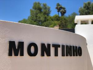 a sign for a moroni inc building at Montinho Boutique Studio in Benagil