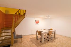a dining room with a table and a staircase at COSY HOME PERIGUEUX in Périgueux +11 photos