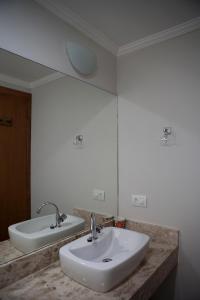 a bathroom with a white sink and a mirror at Casas em Ilhabela, Linda vista, praia Itaguaçu, Vila Paulino, Colibri, Tuim e Tucano in Ilhabela +21 photos