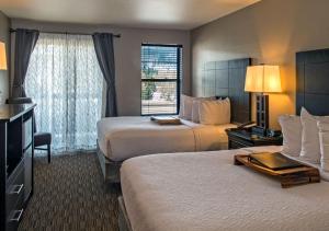 a hotel room with two beds and a television at Breck Inn in Breckenridge