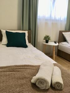 a bed with two towels on it with a window at Apartament 212 in Klikuszowa