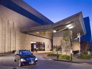 a car parked in front of a building at Grand Millennium Beijing in Beijing