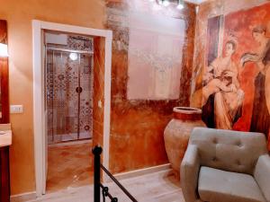 a room with a painting on the wall and a vase at Hotel Villa Antica Tropea in Tropea +41 photos
