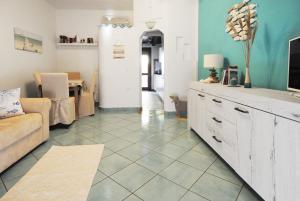 A television and/or entertainment centre at Acquamarina - Exclusive Sea House