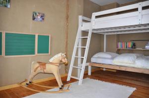a toy horse is standing next to a bunk bed at Ferienhaus Caselow 23 in Bergholz +24 photos