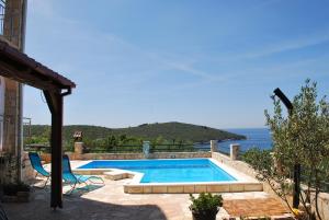 a swimming pool with a view of the ocean at Villa Lunaris in Maslinica