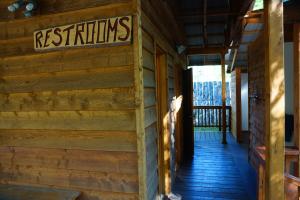 a log cabin with a restaurant sign on the wall at Sven's Basecamp Hostel in Fairbanks