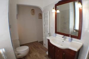 a bathroom with a sink and a toilet and a mirror at Casa Ferrari Testaccio e Trastevere Wi-Fi free in Rome +19 photos