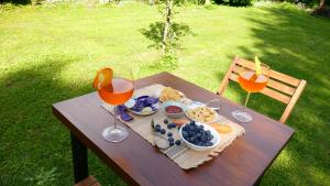 a picnic table with food and two glasses of juice at Casa25- Convenient location to Miland Centre & Como Lake! in Meda