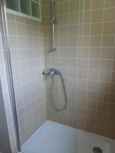 a shower with a glass door in a bathroom at Ti Moutik in Brignogan-Plages +14 photos