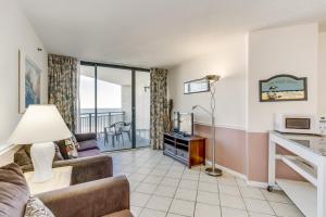 een woonkamer met een bank en een tv bij Scenic Views from the balcony at Ocean Forest Plaza Condos in Myrtle Beach