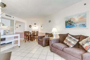 een woonkamer met een bank en een tafel bij Scenic Views from the balcony at Ocean Forest Plaza Condos in Myrtle Beach
