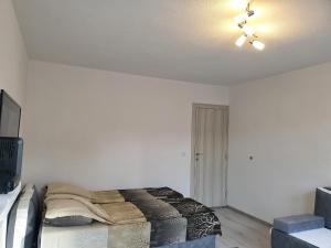 a bedroom with a bed and a ceiling fan at Apartment LejlaM in Sarajevo