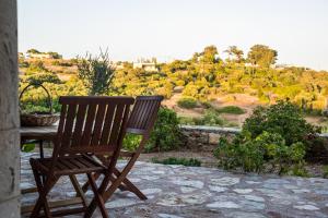 a wooden chair sitting on a patio with a view at Celestia Traditional Houses in Keramoto