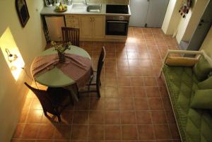 a kitchen and dining room with a table and a couch at Celestia Traditional Houses in Keramoto