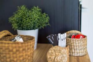three baskets sitting on a table with a potted plant at vilamaria apartment in Porches +13 photos