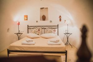 a bedroom with a bed with towels on it at Celestia Traditional Houses in Keramoto