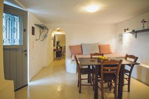 a dining room and kitchen with a table and chairs at Celestia Traditional Houses in Keramoto