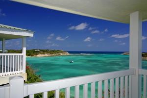 a balcony with a view of the ocean at The Verandah Antigua - All Inclusive - Adults Only in Willikies