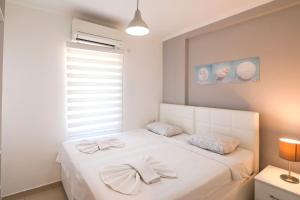 Postel nebo postele na pokoji v ubytování Kasinn Apart Hotel