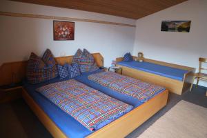 a bedroom with two beds with blue sheets at Haus Kammerlander in Stummerberg