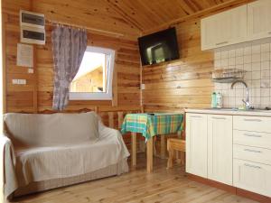 a kitchen with a table in a wooden cabin at Domki letniskowe Wisełka in Wisełka