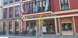 a building with flags in front of a restaurant at Gran Hotel Paraiso in Llanes