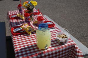a picnic table with a jar of juice and snacks at Orr Family Farm & RR, LLC in Oklahoma City