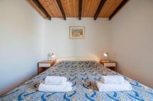 a bedroom with a bed with two towels on it at Apartment Meri - sea view & serenity in Božava