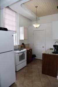 a kitchen with a stove, refrigerator, sink, and dishwasher at EMPIRE INN AND SUITES in Bloomfield