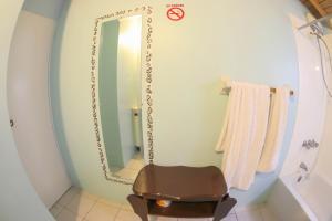 a bathroom with a mirror and a chair in it at Chin Cozy@ Rhyne Park in Montego Bay +15 photos