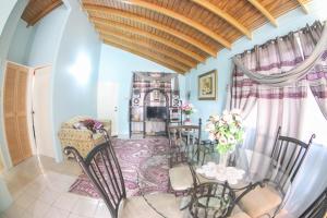 a dining room with a table and chairs at Chin Cozy@ Rhyne Park in Montego Bay