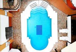 an overhead view of a swimming pool in a building at Del Mar Inn Playas in Tijuana