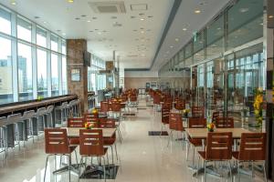 a dining hall with tables and chairs and windows at Toyoko Inn Daegu Dongseongro in Daegu