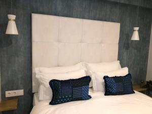 a bedroom with a white bed with two pillows at Canarios Apartments Catarina in Lisbon