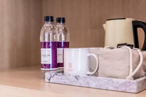 two bottles of water and a cup on a table at Patio 7 in Seoul