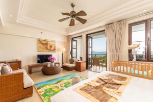 a living room with a bed and a couch at Aegean Suites Sanya Yalong Bay Resort in Sanya