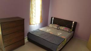a small bedroom with a bed and a dresser at Homestay Melaka Sungai Udang (TSF Qaseh) in Kampong Baharu Sungai Udang