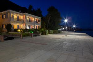 a building with a street light in front of it at Thalassa Apartments in Nydri
