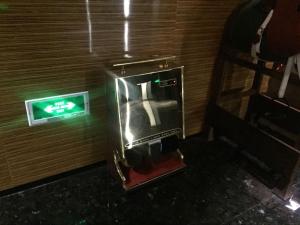 a drink machine in a room with a sign on the wall at Paco Hotel Gangding Metro Guangzhou-Free Shuttle Bus fir Canton Fair in Guangzhou