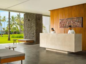 two people standing behind a counter in a lobby at Dialoog Banyuwangi in Banyuwangi