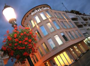 a building with a flower basket in front of it at Hotel Savus in Slavonski Brod